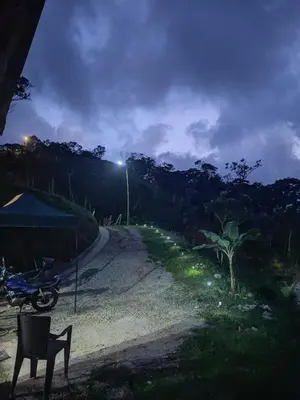 a motorcycle parked on the side of a road at night at Casa Finca cerca al embalse Jaguas San Roque Antioquia