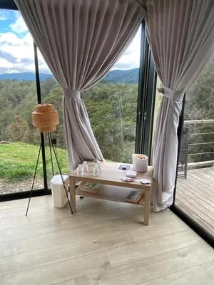 a room with a table and a large window at Aluna's in Guatapé