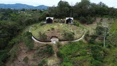 an aerial view of a small house on a hill at Aluna's in Guatapé