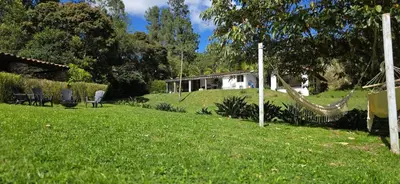 a yard with a hammock and a house at Casa Refugio in Envigado
