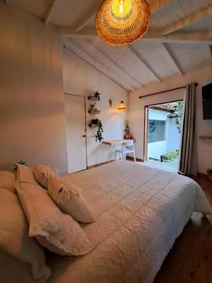 a bedroom with a large bed and a table at Casa Refugio in Envigado