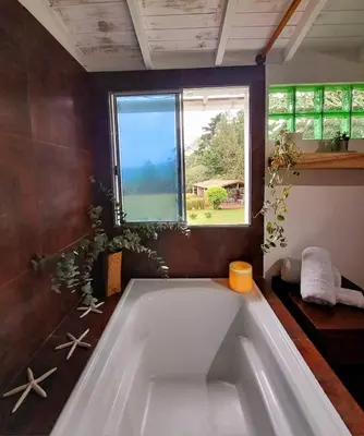 a large bath tub in a bathroom with a window at Casa Refugio in Envigado