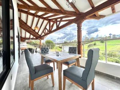 a dining room with a table and chairs at Casa Campestre de Lujo Familiar y Natural in Carmen de Viboral