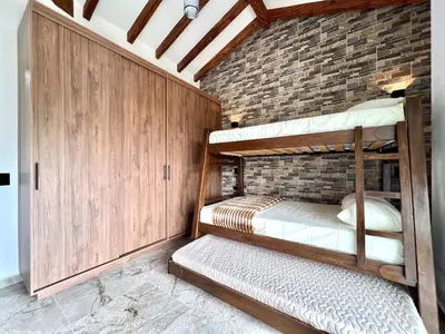 two bunk beds in a room with a brick wall at Casa Campestre de Lujo Familiar y Natural in Carmen de Viboral