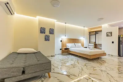 a bedroom with a king sized bed and a bathroom at loft 72 holiday inn medellin in Medellín