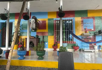 a lobby with a colorful wall with potted plants at Casa de Colores in Guatapé