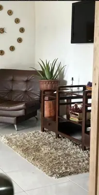 a living room with a couch and a table at Casa de Colores in Guatapé