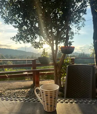 a coffee cup sitting on a table with a view at Casa de Colores in Guatapé