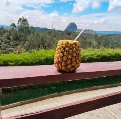 a pineapple sitting on top of a wooden bench at Casa de Colores in Guatapé