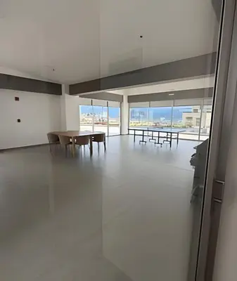 an empty room with tables and chairs and windows at Lujoso con linda vista - Estrato 6 in Manizales
