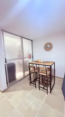 a dining room with a table and two chairs at Apartaestudio completo en Itagüí - Shalom - 201 in Itagüí