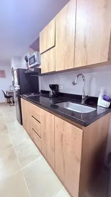 a kitchen with a sink and a refrigerator at Apartaestudio completo en Itagüí - Shalom - 201 in Itagüí