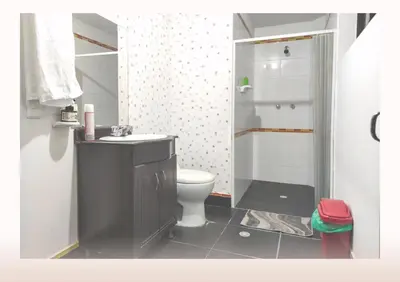 a bathroom with a toilet and a sink and a shower at Hostal Casa Coliving Medellín - Laureles in Medellín