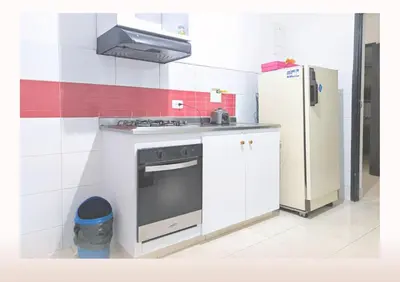 a kitchen with a stove and a refrigerator at Hostal Casa Coliving Medellín - Laureles in Medellín