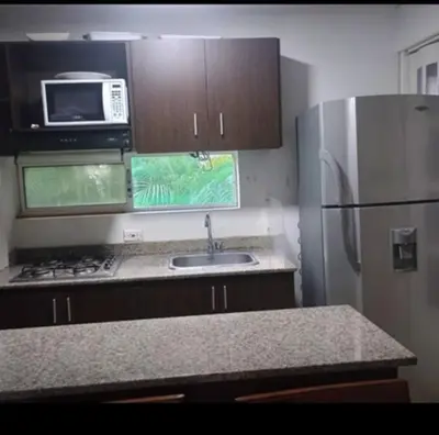 a kitchen with a stainless steel refrigerator and a sink at Ciudadela santafe La Margarita in Santa Fe de Antioquia