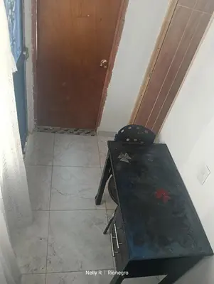a room with a wooden table and a door at Apartaestudio Ríonegro in Rionegro
