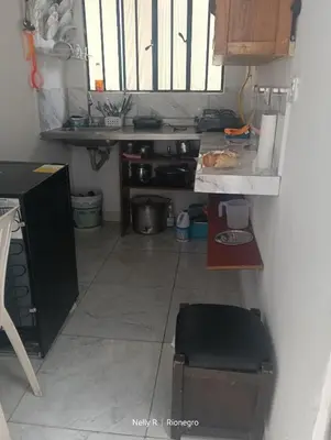 a small kitchen with a counter and a table at Apartaestudio Ríonegro in Rionegro