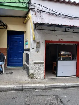 a building with two blue doors on the side of it at Apartaestudio Ríonegro in Rionegro