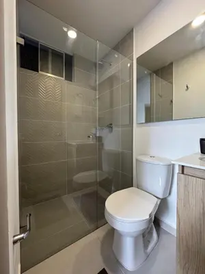 a bathroom with a toilet and a glass shower at Urbanity in Estación El Salto