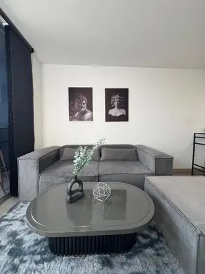 a living room with a couch and a table at Urbanity in Estación El Salto