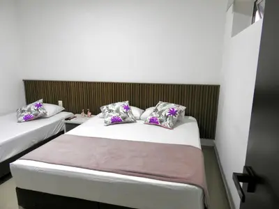 a bedroom with two beds with purple pillows at Mediterraneo Express in Medellín