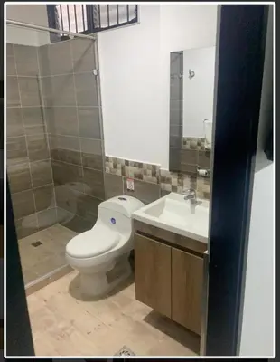 a bathroom with a toilet and a sink at Mediterraneo Express in Medellín