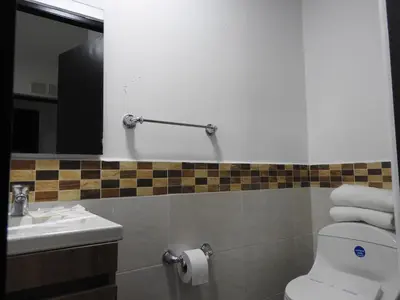 a bathroom with a toilet and a sink at Mediterraneo Express in Medellín
