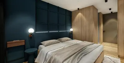 a bedroom with a large bed with blue walls at Autenthico X Atempo Local Hotel & Suites Medellin in Medellín