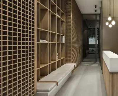 a brick wall with a bench in a hallway at Autenthico X Atempo Local Hotel & Suites Medellin in Medellín