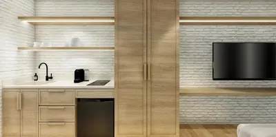 a kitchen with a sink and a tv on a wall at Autenthico X Atempo Local Hotel & Suites Medellin in Medellín