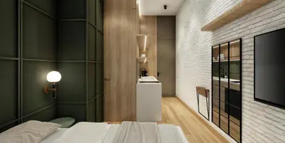 a bedroom with a bed and a tv in a room at Autenthico X Atempo Local Hotel & Suites Medellin in Medellín