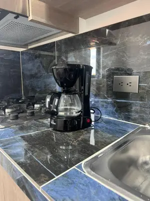 a coffee maker sitting on top of a kitchen counter at aparta hotel del toro in Puerto Triunfo