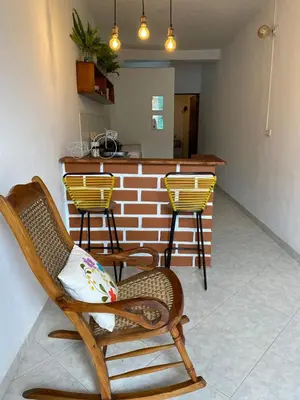 a room with two rocking chairs and a bar at Acogedor apartaestudio cerca al parque principal in Jardin