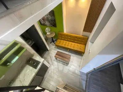 an overhead view of a couch in a living room at la huerta de 1 alcoba in Medellín