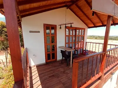 a porch of a house with a desk at Cabaña Sensorial Vista y Silencio Total a 40 minutos de Medellín in San Vicente