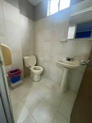 a bathroom with a toilet and a sink at Hotel Brisas del Atanasio in Medellín