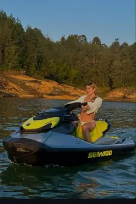 a woman riding on a jet ski in the water at Agua Santa Ecolodge in Guatapé