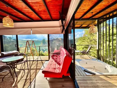 a patio with a hot tub and a table and chairs at Agua Santa Ecolodge in Guatapé