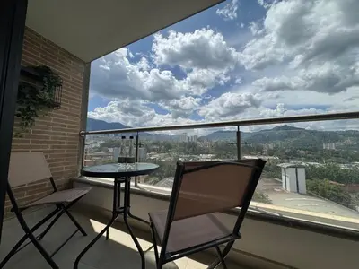 a balcony with a table and chairs and a view at Aluna in Estación El Salto