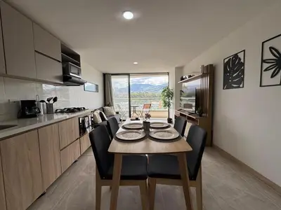 a kitchen and dining room with a table and chairs at Aluna in Estación El Salto
