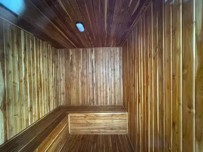 a sauna with wooden walls and a wooden floor at Aluna in Estación El Salto