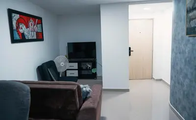 a living room with a couch and a tv at 801-Acogedor Apto 2BR Parque Sabaneta in Sabaneta
