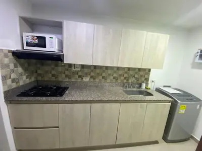 a small kitchen with a sink and a microwave at 801-Acogedor Apto 2BR Parque Sabaneta in Sabaneta