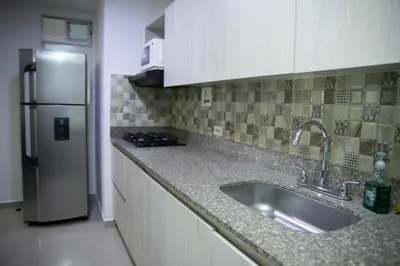 a kitchen with a sink and a refrigerator at 801-Acogedor Apto 2BR Parque Sabaneta in Sabaneta