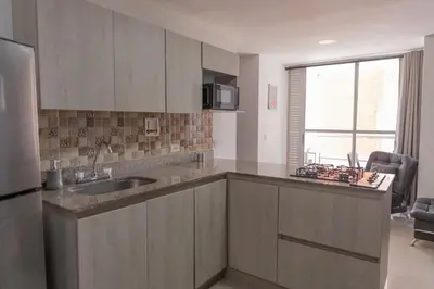 a kitchen with a sink and a refrigerator at 504-Apartamento 3BR a Pasos del Parque de Sabaneta in Sabaneta