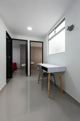 a dining room with a table and a window at 1101- Cozy 2BR Apartment near Sabaneta Park in Sabaneta