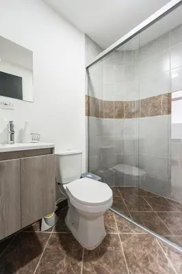 a bathroom with a toilet and a shower at 1101- Cozy 2BR Apartment near Sabaneta Park in Sabaneta