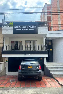 a car parked in front of a building at Absolute Nova Hotel in Medellín