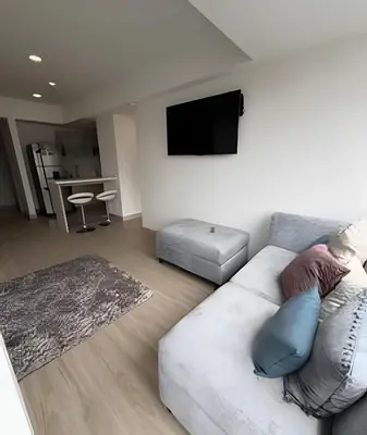 a living room with a couch and a flat screen tv at Acogedor y Moderno - Estrato 6 in Manizales
