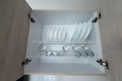 an open refrigerator door with dishes and utensils at Acogedor y Moderno - Estrato 6 in Manizales